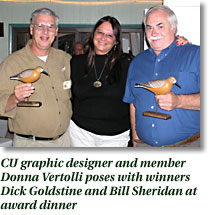 CU graphic designer and member Donna Vertolli poses with winners Dick goldstine and Bill Sheridan at award dinner