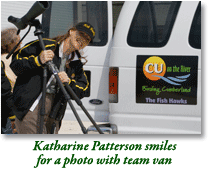 Katherine Patterson smiles for a photo with the team van