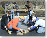 Boy scouts constructing osprey nesting box