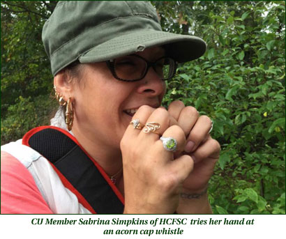 CU Member Sabrina Simpkins of HCFSC tries an acorn cap whistle