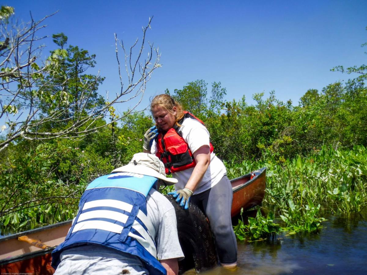 Karla Rossini and Tom Glynn remove a tire from the Wild and Scenic Maurice River at the volunteer work group held on June 11th.